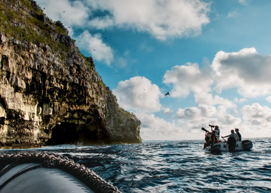 Tourists on a panga observing the island