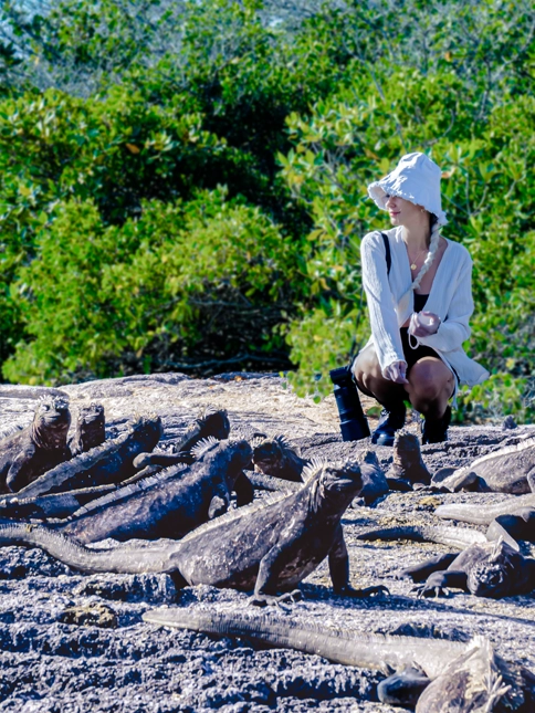 Woman admiring the landscape alongside iguanas - Galaxy Cruises - B2B info